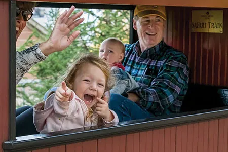 Image - A family riding on the North Shore Bank Safari Zoo Train at the Milwaukee County Zoo.